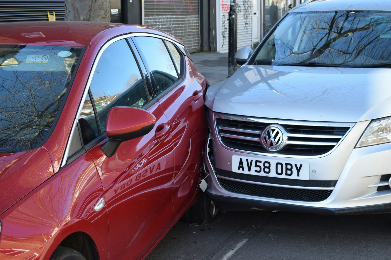 two cars parked next to each other in a parking lot, auto